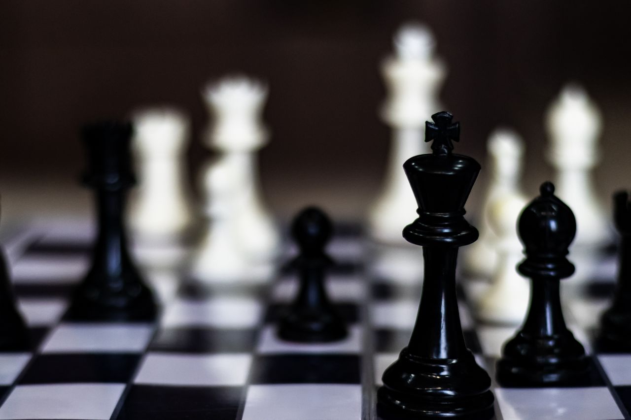 Mastering the First Impression: Your intriguing post title goes here Close-up view of a chess game in progress, showcasing strategic black and white pieces.